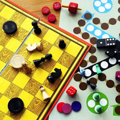 chess and go boards with red, yellow, blue, black and green game pieces